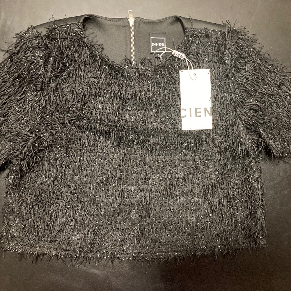 Black fashion top with details in front and zipper in the back (new).